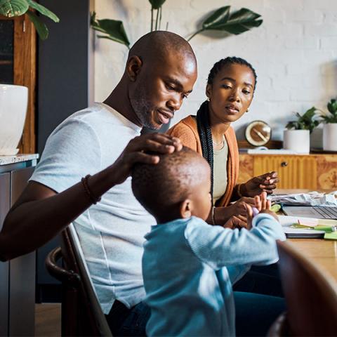 A family working together on a laptop