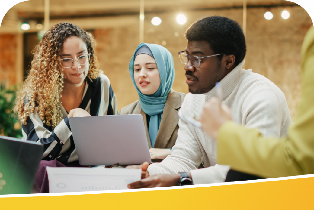 A group of people brainstorming using a laptop.