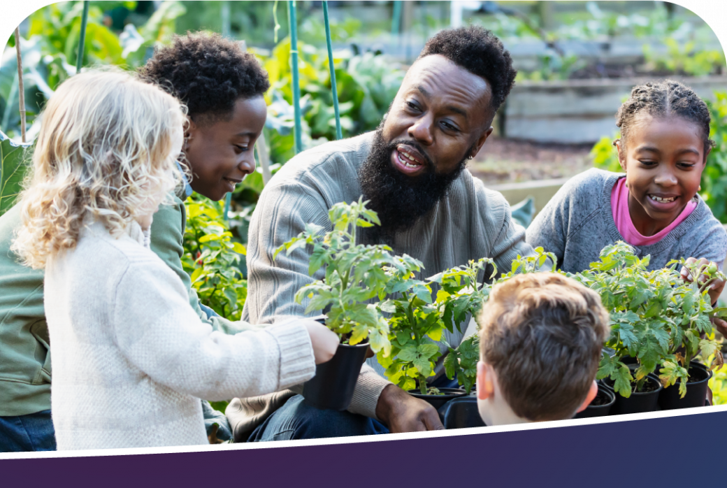 A group of students learning about plants with the teacher.