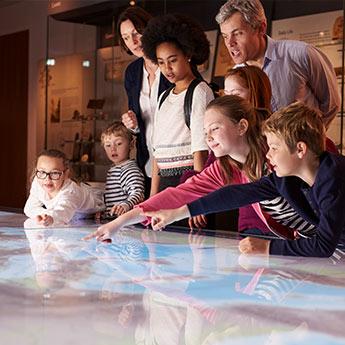 Children actively engage in learning at a museum.