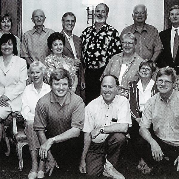 Image en noir et blanc du groupe des présidents des équipes d’évaluation des demandes de subvention en Ontario pour 2003, assis et debout pour une photo officielle.