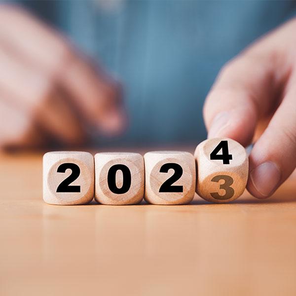 Hand changing wooden blocks from 2023 to 2024.