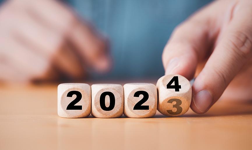 Mains changeant des cubes de bois de l’année 2023 à 2024.