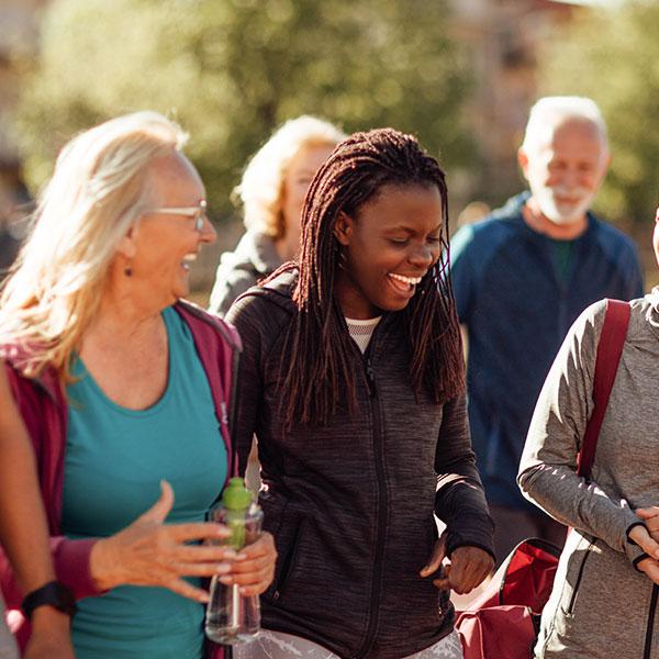 A group of people laughing together outdoors.