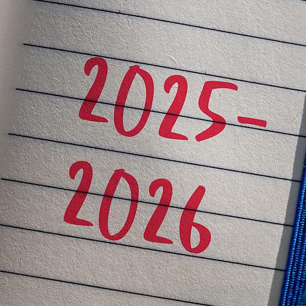 The year 2025 and 2026 written on a notepad.