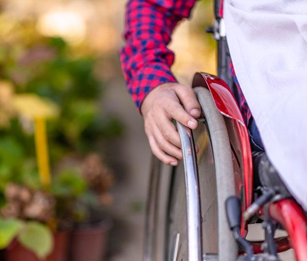 A Man in a wheelchair enjoying time outdoors.