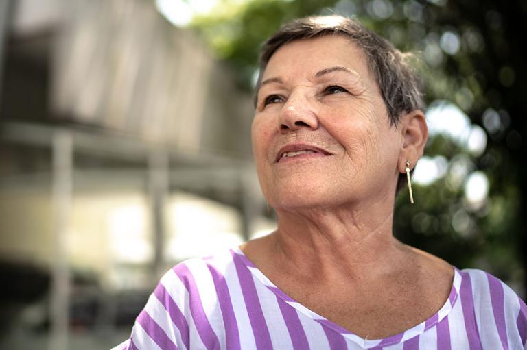 Elderly lady looking off into the distance while smiling