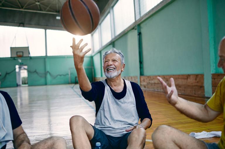 Close up of a group of seniors relaxing after playing basketball