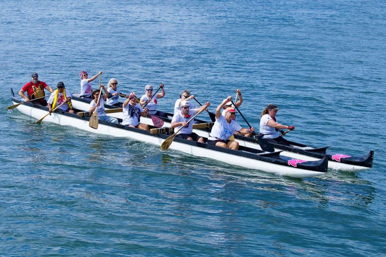 A group of people are canoeing on a lake